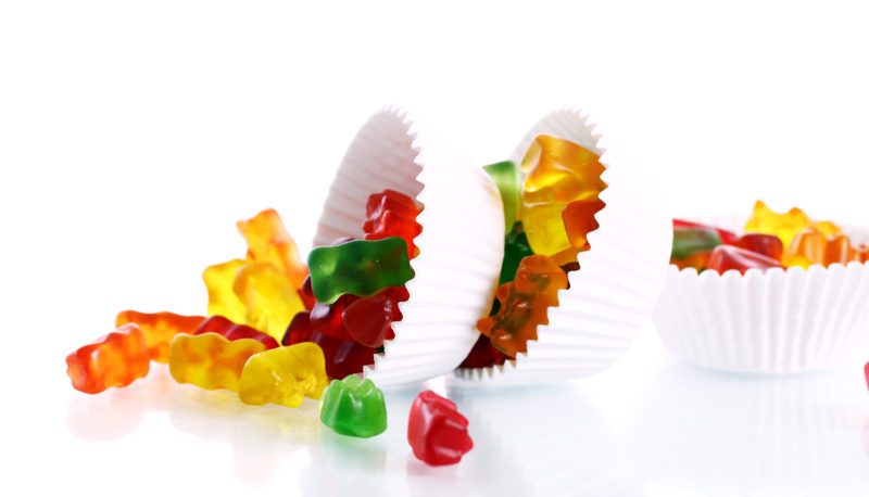 Colorful gummy bear candies over white background